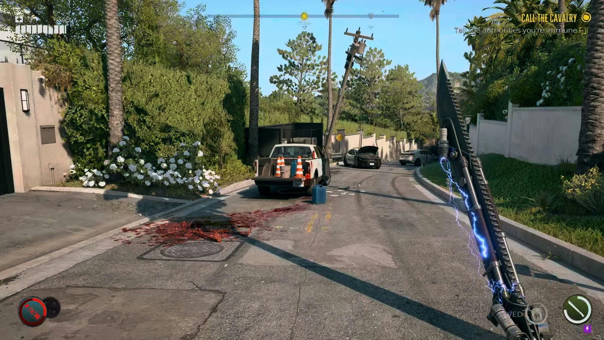 A screenshot from Dead Island 2 depicting a road with a bloodstain. An electrified sword in the foreground.